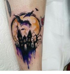 a person with a tattoo on their leg that has an image of a castle in the background