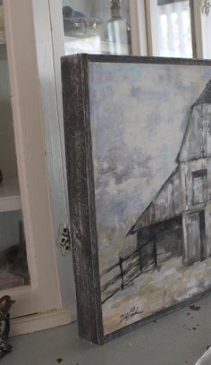 an old barn painting is on display in front of a white door with glass panes