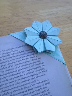 an origami flower on top of a book