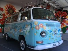 an old vw bus painted with flowers and butterflies