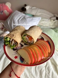 a person holding a plate with an apple and cheese sandwich on it that is cut in half