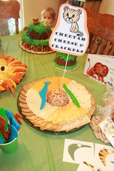 a green table topped with cakes and desserts