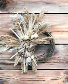 dried flowers are arranged on a wooden surface