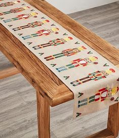 a wooden bench with a table runner on it