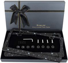 an open gift box with three pairs of earrings in the front and one pair on the back