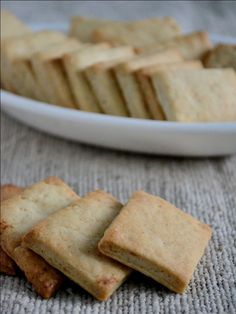 some crackers are on a table next to a bowl