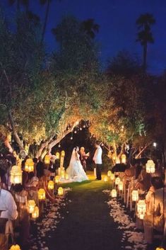 a wedding ceremony with candles lit up at night