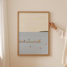 a woman standing next to a painting on the wall