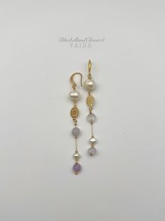 Freshwater pearl and Amethyst Gold, Long ,Statement earrings I have combined the Freshwater Pearls with Light purple Amethyst and a beautiful gold filled connector  Earring drop length is about 8.5 cm Earring Findings are 14k gold filled   Because pearls are a natural product, the colours, patterns and shapes (particularly with baroque pearls) vary from piece to piece. This means your earrings will be completely unique as no two baroque pearls will ever be identical. Pearls are associated with purity, integrity, and the loyalty of their wearer - which explains their continued popularity in wedding jewellery.  Pearls symbolise wisdom. They are believed to attract wealth and luck as well as offer protection Comes gift wrapped ready to give or to keep Elegant Lavender Earrings With Ear Wire, Elegant Lavender Dangle Jewelry, Elegant Purple Gemstone Pearl Earrings, Elegant Natural Stone Pearl Earrings For Anniversary, Elegant Amethyst Earrings With Pearl Drop, Elegant Amethyst Pearl Drop Earrings, Elegant Amethyst Earrings With Natural Stones, Elegant Amethyst Earrings As A Gift, Elegant Handmade Lavender Earrings