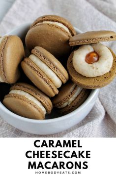 a bowl filled with cookies and macarons on top of a white table cloth