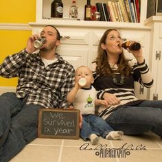 a man and woman are sitting on the floor drinking from their baby's bottles