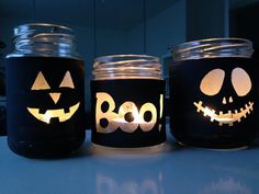 three mason jars decorated with jack o lantern faces