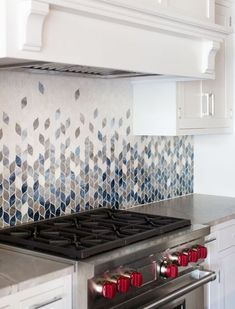 a stove top oven sitting inside of a kitchen next to a wall mounted oven hood