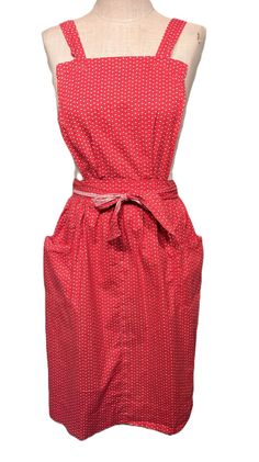 a red and white polka dot dress on a mannequin