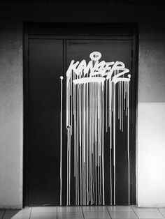 an open door with graffiti on it in black and white