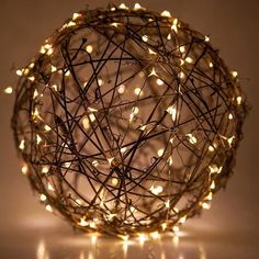 a ball covered in lights sitting on top of a table