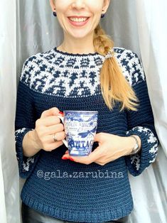 a woman holding a cup in her hands