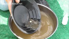 someone is pouring some liquid into a metal bowl