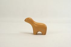 a small wooden toy animal on a white background