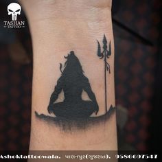 a tattoo on the wrist of a person with a silhouette of a man holding a spear