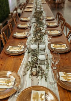 a long table with plates and place settings on it