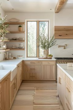 Bright modern kitchen with wooden cabinets, open shelving, and a large window over the sink. White Counter Kitchen Ideas, Small Natural Kitchen, Natural Look Kitchen, Natural Organic Home Decor, Oak Kitchen Ideas Modern, Modern Chic Kitchen Ideas, Earthy Minimalist Kitchen, Modern Minimalist Interior Design Kitchen, Light And Natural Kitchen