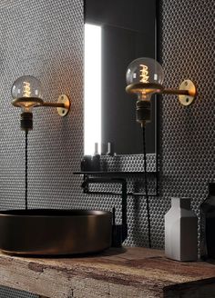 a bathroom sink with two lights above it