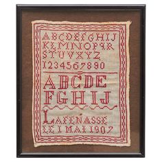 an old fashioned cross stitch sample with the letters and numbers in red, white and black