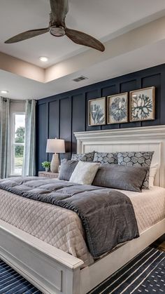 a bedroom with a large bed and ceiling fan