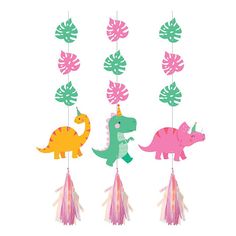 three dinosaur mobiles with tassels hanging from the ceiling, one pink and one green