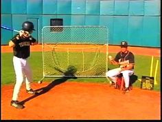 a man holding a baseball bat standing next to a catcher and umpire on a field