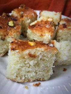 a white plate topped with pieces of cake