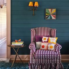 a chair and table in a room with blue walls