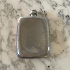 a silver flask sitting on top of a marble counter