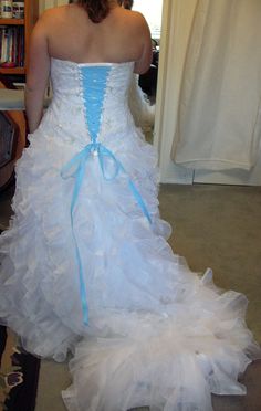 a woman in a white and blue wedding dress