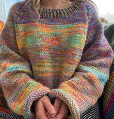 a close up of a person wearing a colorful sweater