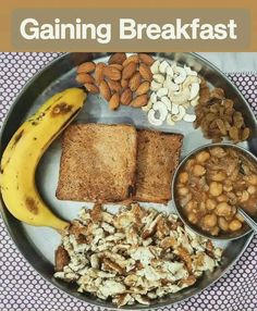 a plate with toast, nuts, bananas and other food on it that says gaining breakfast