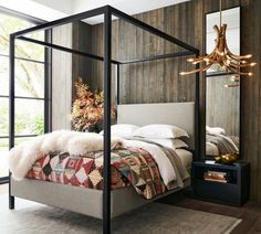 a bedroom with a canopy bed and wooden walls