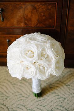 a bouquet of white flowers sitting on top of a table