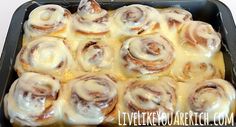 a pan filled with cinnamon rolls covered in icing