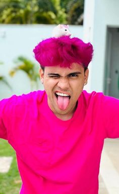 a man with purple hair making a funny face