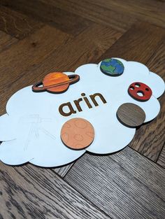 a wooden floor with a sign that says arrn and some pictures of planets on it