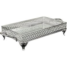 a glass tray with ornate designs on the bottom and legs, sitting on a white surface