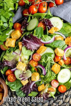 mixed green salad with croutons, cucumbers, tomatoes and lettuce