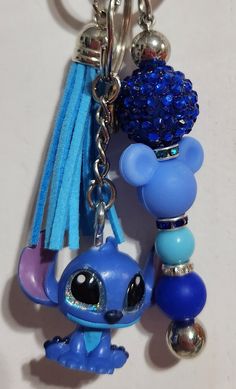 a blue keychain with a littlest pet charm hanging from it's side