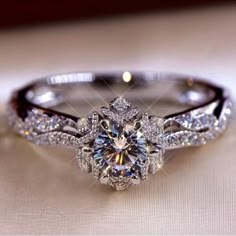 a diamond engagement ring sitting on top of a table