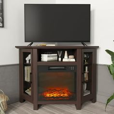 an entertainment center with a fireplace and flat screen tv