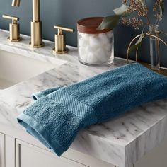 a blue towel sitting on top of a bathroom counter