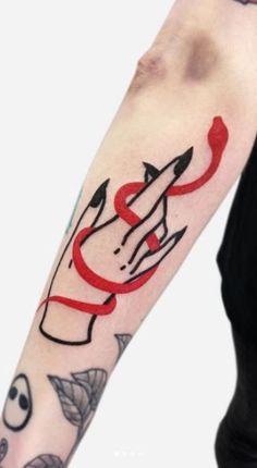 a person with a tattoo on their arm and the word love written in red ink