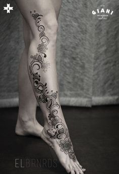 a woman's legs with tattoos on them